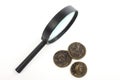 Magnifying glass and fake ancient coins Royalty Free Stock Photo