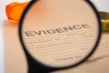 Magnifying glass focus on evidence bag Royalty Free Stock Photo