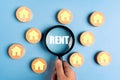 Magnifying glass focus rent word. The concept of renting housing and real estate. The cost of a rented home or apartment