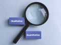 Magnifying Glass Focusing on Qualitative and Quantitative Text Blocks Representing Research Methods and Data Analysis Royalty Free Stock Photo