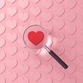 Magnifying glass focusing on red heart among other pink hearts isolated on pink pastel color background Royalty Free Stock Photo