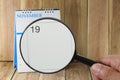 Magnifying glass in hand on calendar you can look Nine Day of mo
