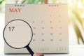 Magnifying glass in hand on calendar you can look seventeenth da Royalty Free Stock Photo