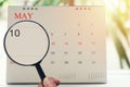 Magnifying glass in hand on calendar you can look tenth day of m