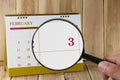 Magnifying glass in hand on calendar you can look third day of m