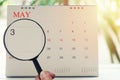 Magnifying glass in hand on calendar you can look third day of m