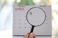 Magnifying glass in hand on calendar you can look third day of m