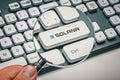 Magnifying glass in hand focused on computer key solana token logo