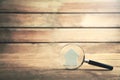 Magnifying glass with house on wooden background. Property inspection Royalty Free Stock Photo