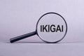 Magnifying glass with the inscription IKIGAI on a light gray background