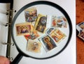 Magnifying glass with with interesting postage stamps.