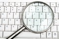 Magnifying glass on keyboard Royalty Free Stock Photo