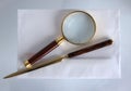 Magnifying glass and a letter opener Royalty Free Stock Photo