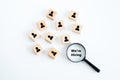 Magnifying glass looking for employees on wood cube. Human resources management and recruitment business hiring concept.