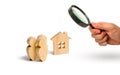 Magnifying glass is looking at the A group of people standing near the apartment building. Lending to buy a house. Ownership Socie