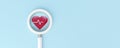 Magnifying glass looking to icon health cardio on blue background