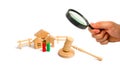 Magnifying glass is looking at the Wooden apartment house with people, keys and a judge hammer on a white background. The concept Royalty Free Stock Photo