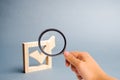 Magnifying glass is looking at the wooden checkmark for voting on elections on a gray background. Presidency or parliamentary Royalty Free Stock Photo