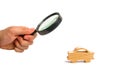 Magnifying glass is looking at the Wooden figurine of a car on a white background. Minimalism. The concept of car insurance, buyin Royalty Free Stock Photo