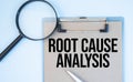 Magnifying glass loupe with sign Root Cause Analysis blue table Royalty Free Stock Photo