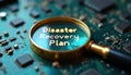 Magnifying glass magnifies Disaster Recovery Plan on circuit board. Concept of planning, data backup, security. Emergency Royalty Free Stock Photo