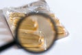 Magnifying glass medications close up macro shot. Royalty Free Stock Photo