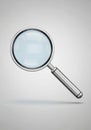 Magnifying glass with a metallic silver handle and rim. The lens is clear, showcasi Royalty Free Stock Photo