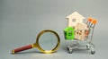Magnifying glass and miniature wooden houses. House searching concept. Home appraisal. Property valuation. Choice of location for Royalty Free Stock Photo