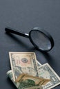 Magnifying glass and money on black background. Paper currency. Looking For Money Royalty Free Stock Photo