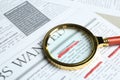 Magnifying glass on newspaper. Job search Royalty Free Stock Photo