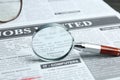 Magnifying glass on newspaper. Job search concept Royalty Free Stock Photo