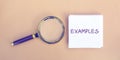 Magnifying glass and a note with the word Examples. Example, instance, sample. Business, marketing and training concept. Flat lay