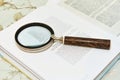 Magnifying glass on open book Royalty Free Stock Photo