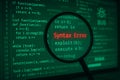 Magnifying glass over computer code showing syntax error Royalty Free Stock Photo