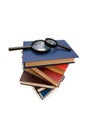 Magnifying glass over the stack of books Royalty Free Stock Photo