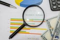 Magnifying glass, pen, calculator, and business documents, graphs and charts with information on profit and sales. Royalty Free Stock Photo