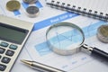 Magnifying glass, pen and calculator on financial chart and grap Royalty Free Stock Photo