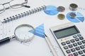 Magnifying glass, pen, glasses and calculator on financial chart Royalty Free Stock Photo