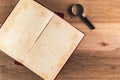 Magnifying glass and pile of old book Royalty Free Stock Photo