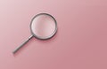 Magnifying glass on pink background top view lying flat copy space concept