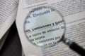 A magnifying glass points to the Spanish words commissions, fees and expenses on a bank document