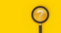 Magnifying glass with question mark on yellow background, search, question answer, problem or business solution concept