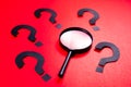 Magnifying Glass and Question Marks Royalty Free Stock Photo