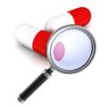 Magnifying glass and red medical pills on white Royalty Free Stock Photo