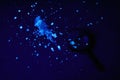 Exploring glowing substances under a magnifying glass at night Royalty Free Stock Photo