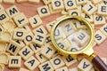 Magnifying glass and scrabble letters. Scrabble is a word game first and foremost. Playing Scrabble will expand your vocabulary