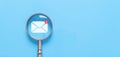 magnifying glass shows an icon for new email, sending an information message email from the tablet. smart SMS mail on digital. Royalty Free Stock Photo