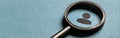 A magnifying glass symbolizing talent acquisition and personal data analysis is centered on a user profile icon within a Royalty Free Stock Photo