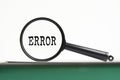 Magnifying glass with text Error on notebook Royalty Free Stock Photo