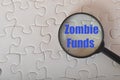 Magnifying glass with text ZOMBIE FUNDS.A zombie fund (more formally known as a closed fund) is a colloquial expression Royalty Free Stock Photo